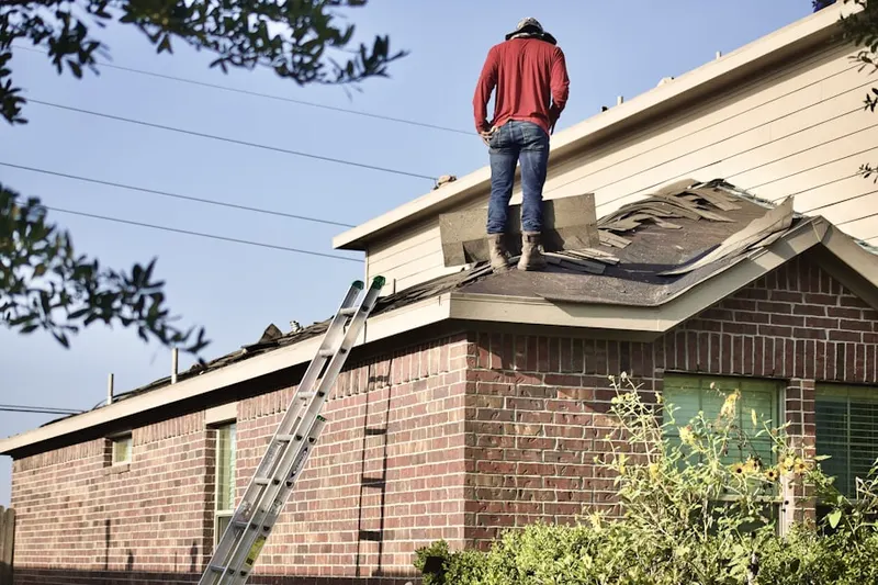 Professional roofer working on a residential roof in Orange Grove Villas